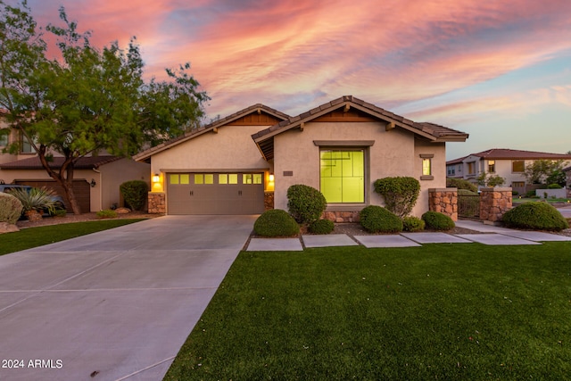 view of front of property featuring a garage and a lawn