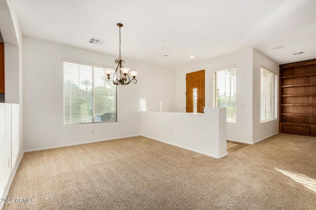 unfurnished office featuring carpet flooring, ceiling fan, and a wealth of natural light