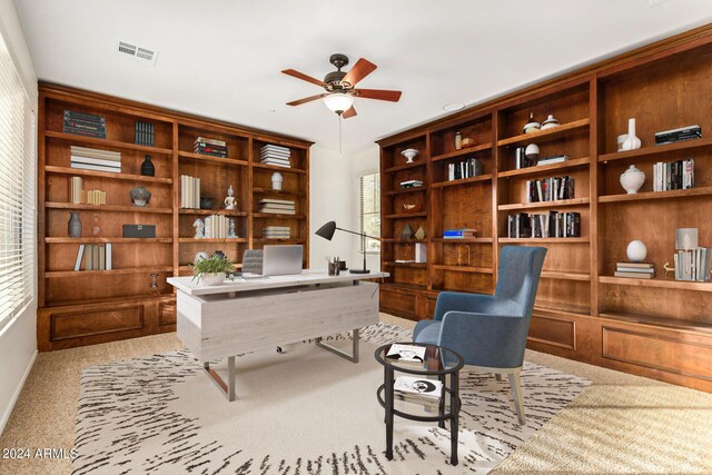 unfurnished living room featuring light carpet and ceiling fan