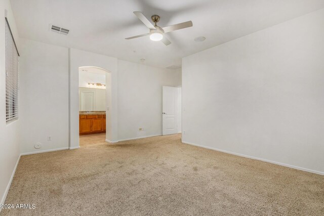 unfurnished bedroom featuring light carpet, ceiling fan, and a closet