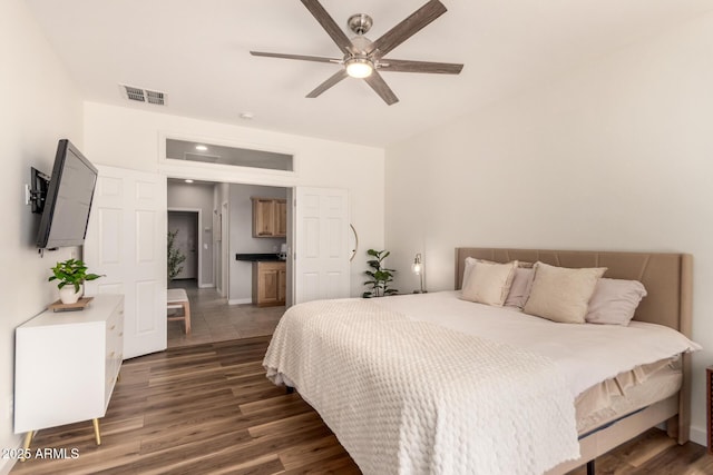 bedroom with ceiling fan and dark hardwood / wood-style flooring