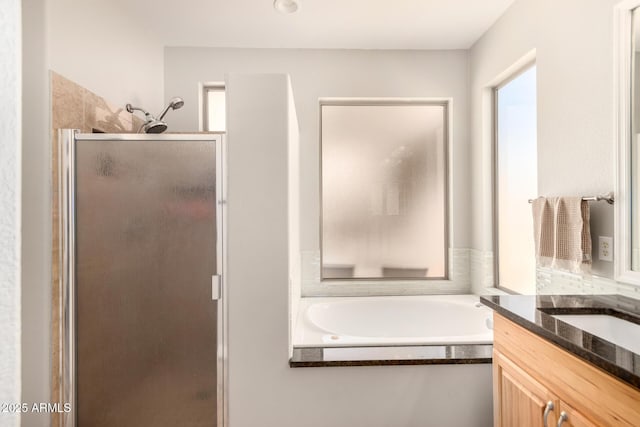 bathroom featuring vanity and separate shower and tub