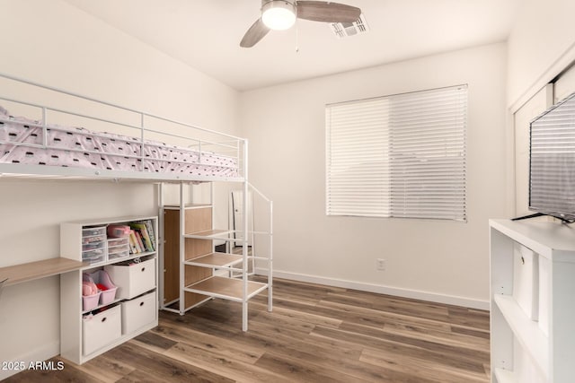 bedroom with ceiling fan and dark wood-type flooring