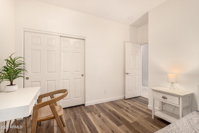 bedroom featuring a closet and dark wood-type flooring