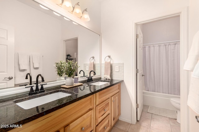 full bathroom featuring toilet, vanity, tile patterned floors, and shower / bath combo with shower curtain