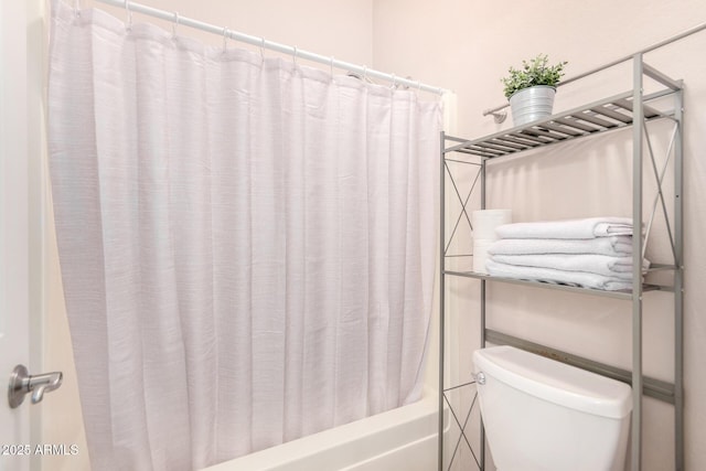 bathroom featuring toilet and shower / bathtub combination with curtain