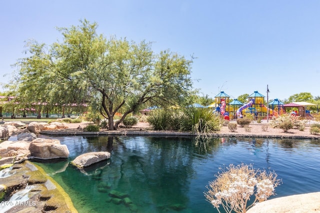 view of swimming pool with a playground