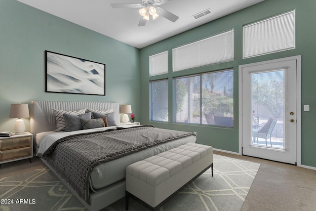 carpeted bedroom with ceiling fan and access to exterior