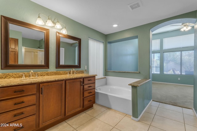 bathroom featuring a bathing tub, ceiling fan, vanity, and tile patterned floors