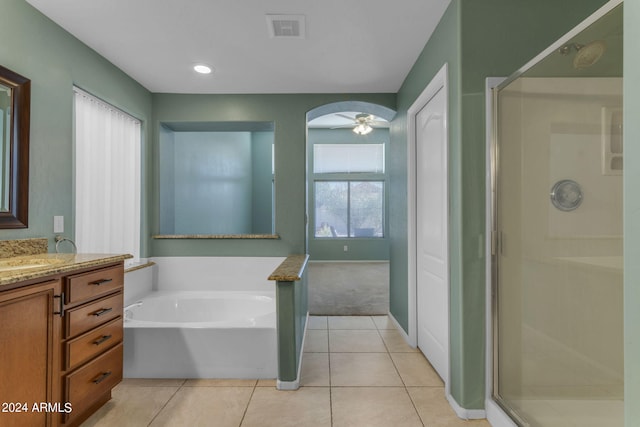 bathroom featuring ceiling fan, vanity, plus walk in shower, and a healthy amount of sunlight