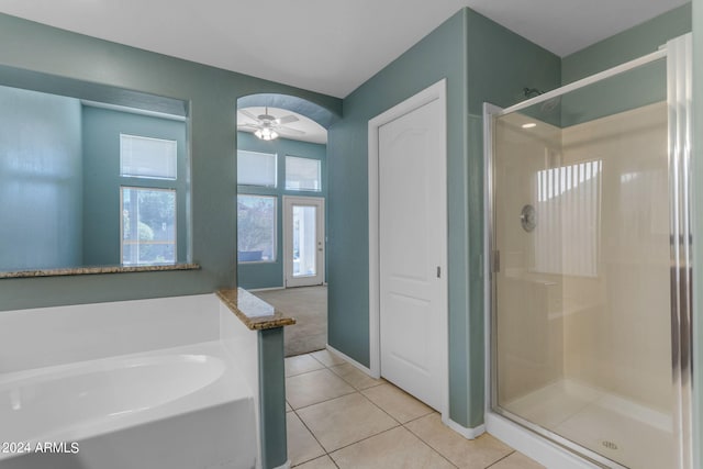 bathroom with ceiling fan, plenty of natural light, tile patterned floors, and separate shower and tub