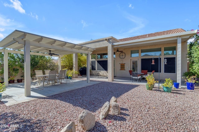 back of property featuring a pergola, ceiling fan, and a patio area