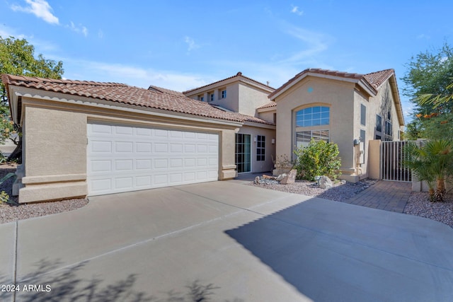 mediterranean / spanish-style house with a garage