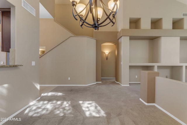 interior space with a high ceiling and a chandelier