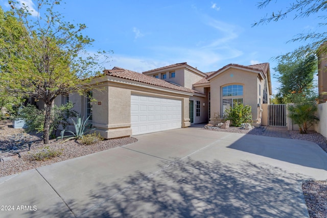 mediterranean / spanish house featuring a garage