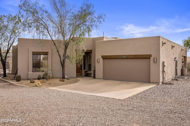 pueblo-style home featuring a garage