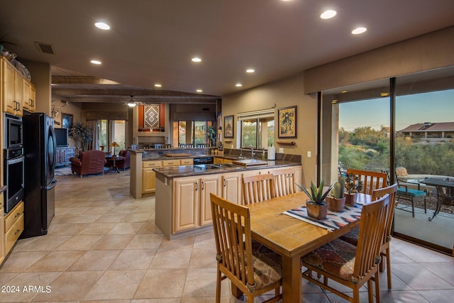 dining area with light tile floors, sink, and beamed ceiling