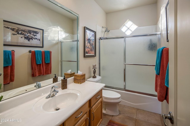 full bathroom featuring toilet, combined bath / shower with glass door, tile floors, and vanity