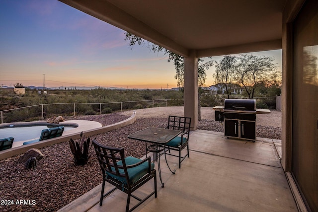 view of patio terrace at dusk