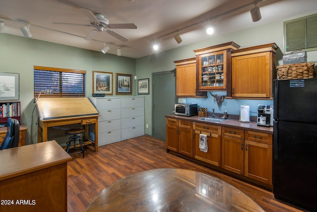 kitchen featuring black fridge, sink, and rail lighting