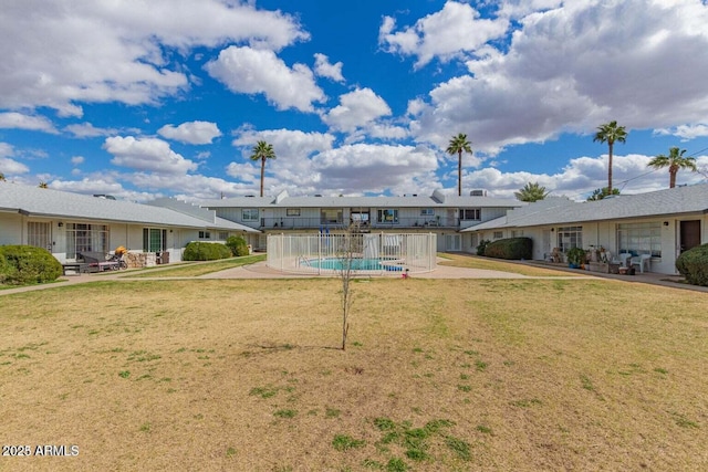 rear view of property featuring a yard and a patio area