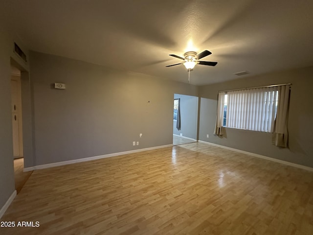 empty room featuring ceiling fan and light hardwood / wood-style floors