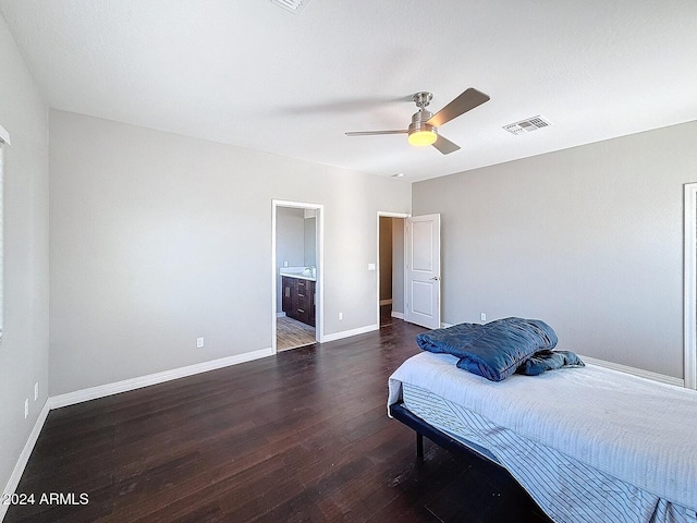 bedroom with ceiling fan, dark hardwood / wood-style flooring, and ensuite bath