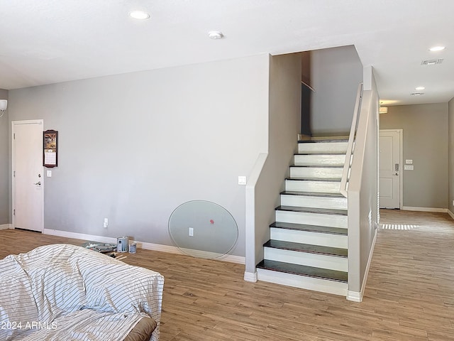 stairs featuring wood-type flooring