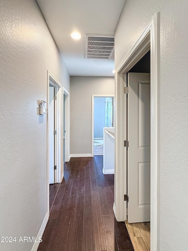 hall with dark wood-type flooring