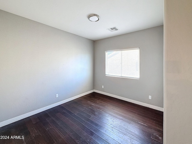 empty room featuring dark wood-type flooring