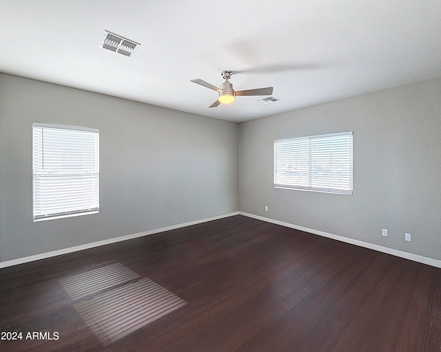 empty room featuring ceiling fan and dark hardwood / wood-style floors