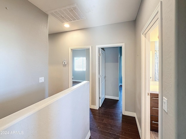 corridor with dark hardwood / wood-style flooring