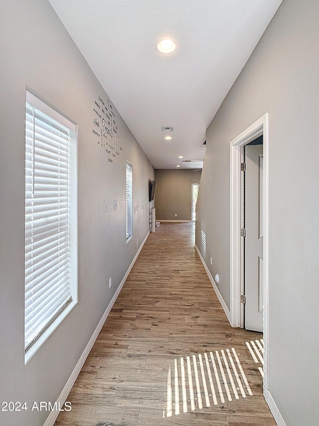 corridor with light hardwood / wood-style flooring