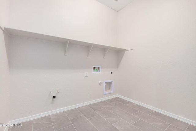 laundry room with hookup for a washing machine, electric dryer hookup, hookup for a gas dryer, and light tile patterned floors