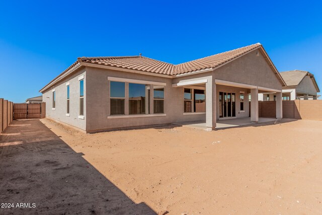 back of property featuring a patio area