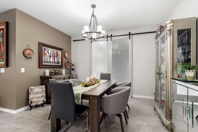 tiled dining area with a barn door and an inviting chandelier