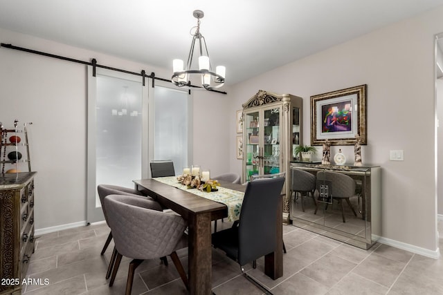 tiled dining space with an inviting chandelier and a barn door