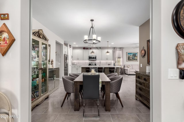 dining room featuring an inviting chandelier and light tile patterned floors