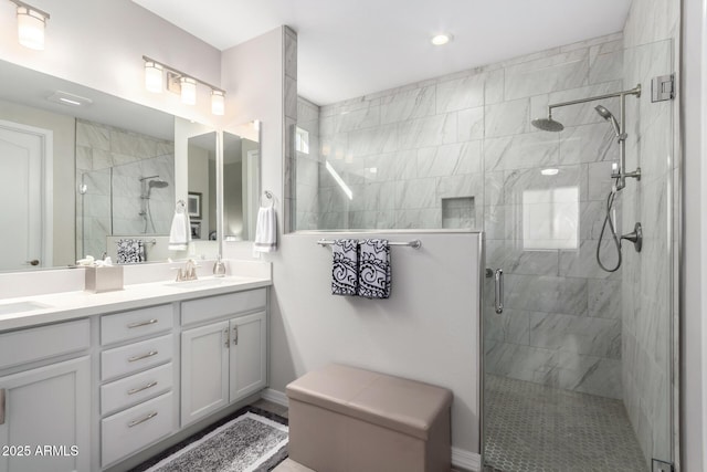 bathroom with a shower with door and vanity