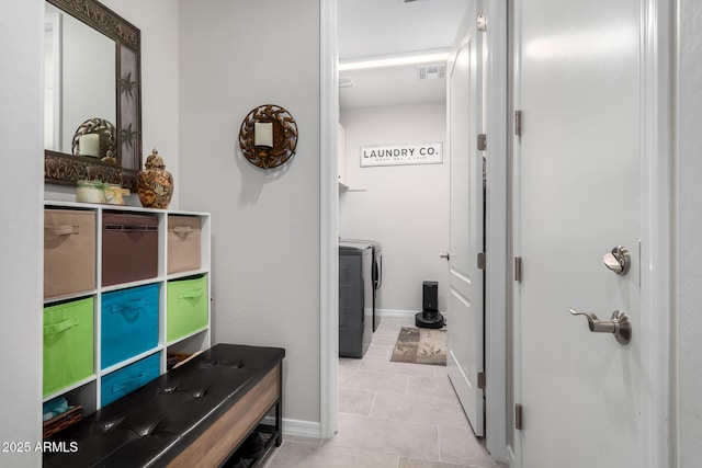 bathroom with separate washer and dryer and tile patterned floors