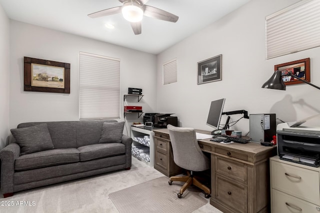 carpeted office space with ceiling fan