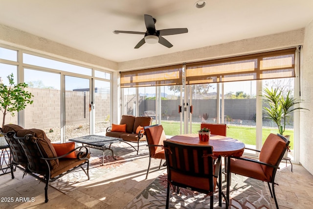 sunroom / solarium with ceiling fan and a wealth of natural light