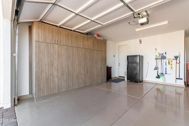 garage featuring black fridge and a garage door opener