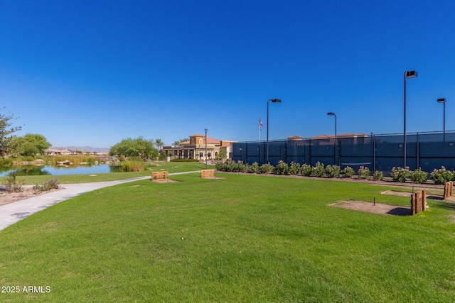 view of community with a water view and a lawn