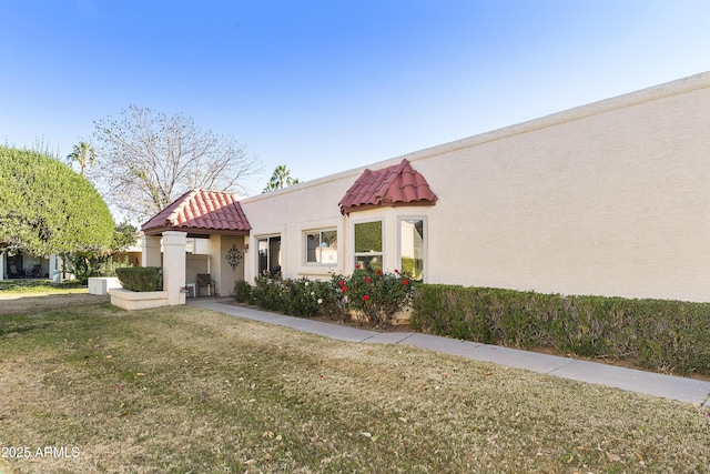 mediterranean / spanish-style house with a front lawn