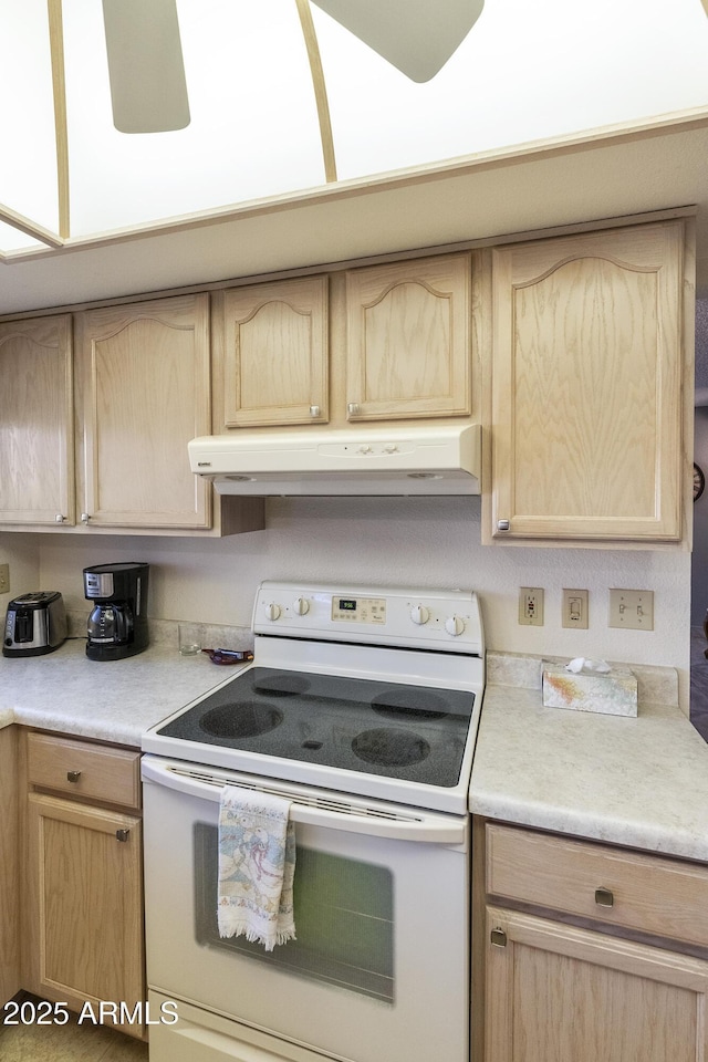 kitchen with light brown cabinets and electric stove