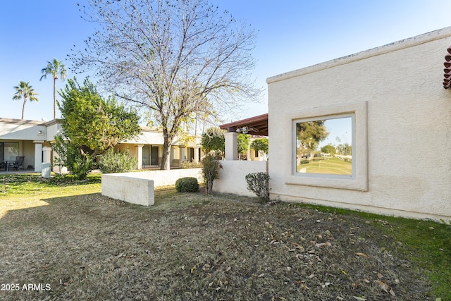 view of side of home featuring a yard