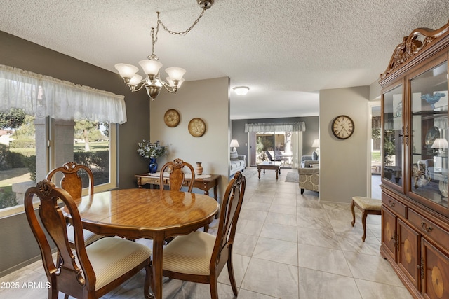 dining space featuring a textured ceiling and an inviting chandelier