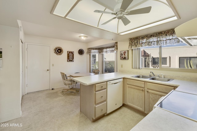 kitchen with kitchen peninsula, ceiling fan, white appliances, light brown cabinetry, and sink