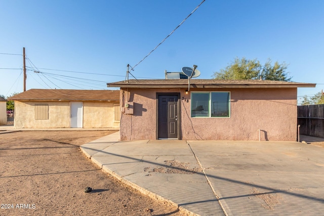 back of property with a patio